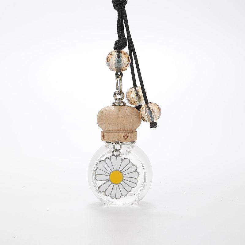 Clear oval car diffuser bottle with daisy ornament, wooden cap and beaded cord