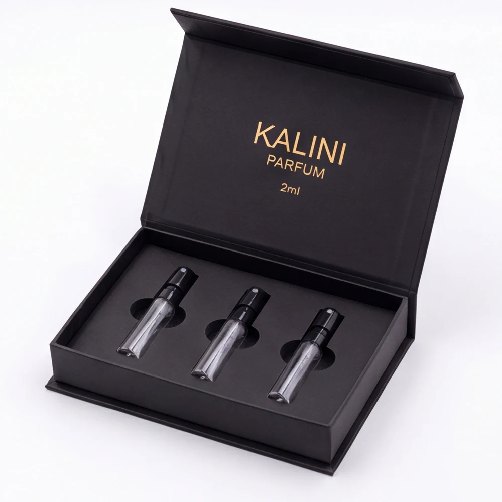 Three perfume sample vials in a fitted black hinged discovery-set box
