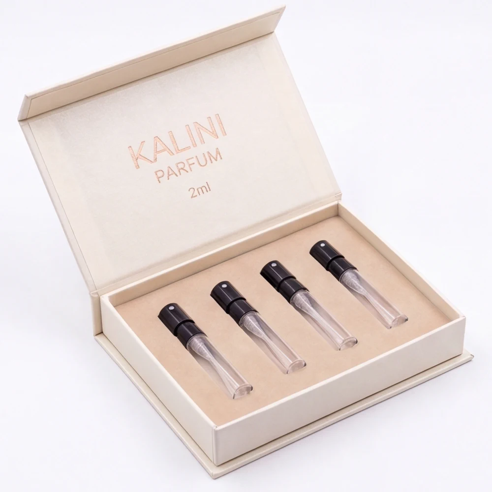 Four perfume sample vials in an open cream hinged box