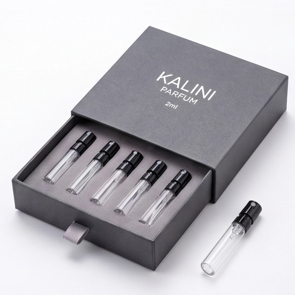 Five perfume sample vials in a gray drawer box with one vial displayed outside