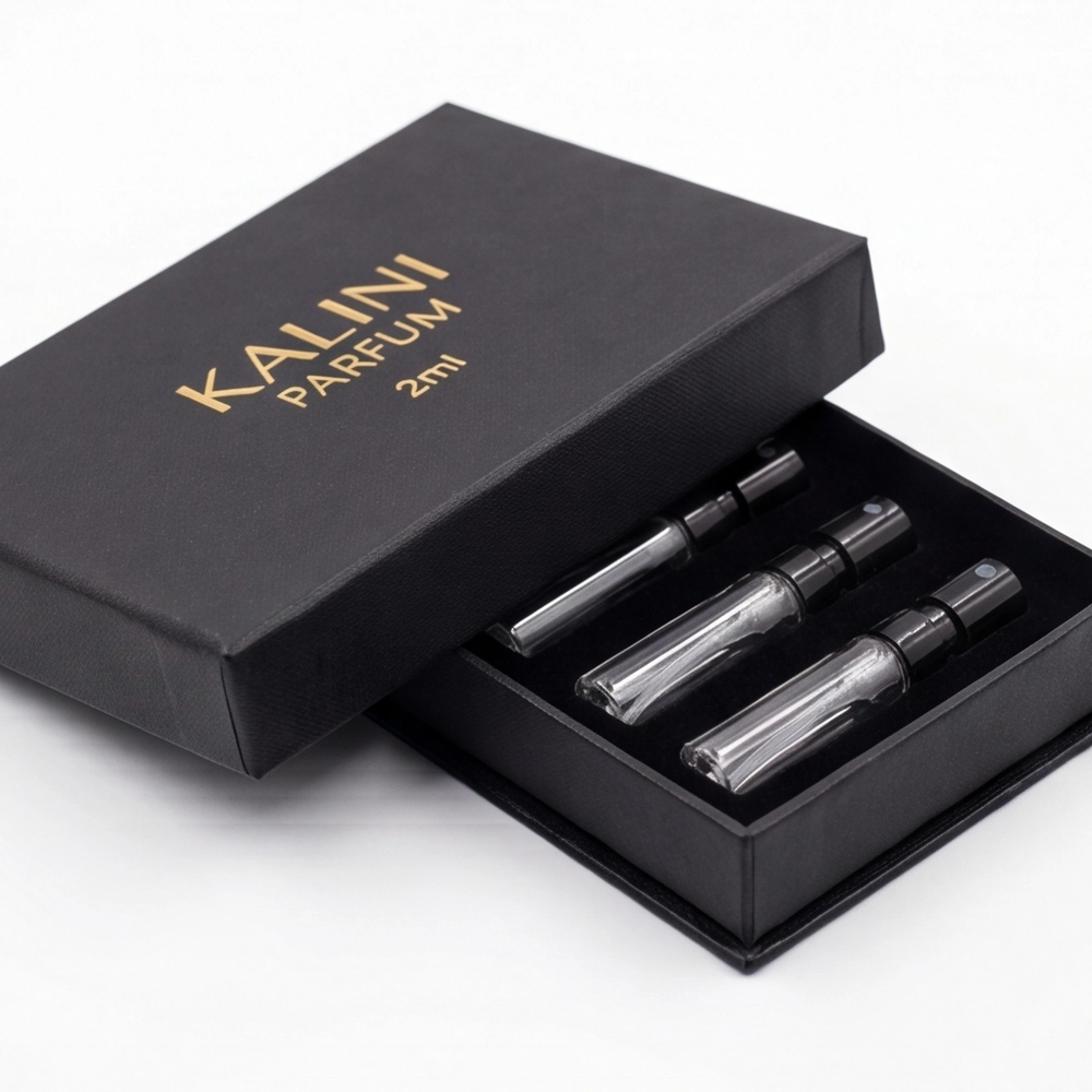 Three perfume sample vials in a compact black rigid presentation box